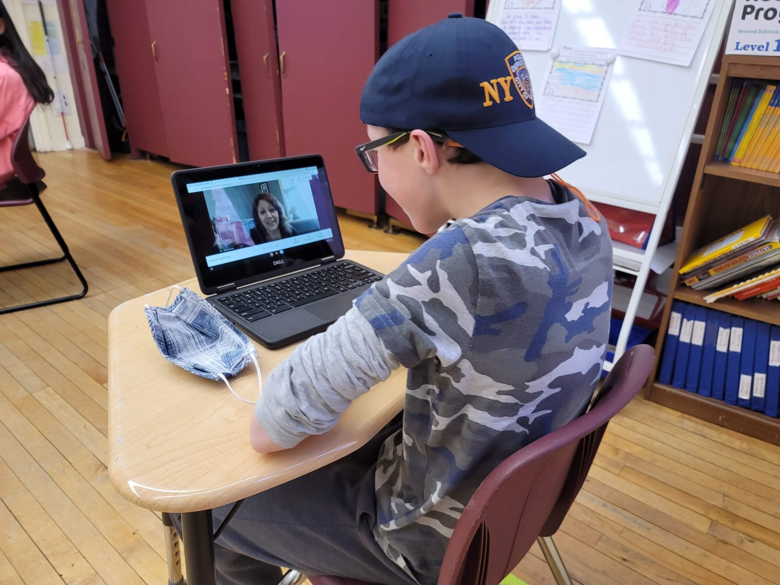 Student on laptop doing a video call with teacher